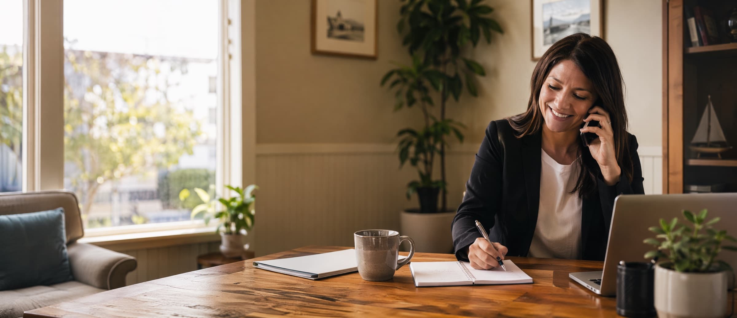 A friendly advisor smiling while helping a client on the phone